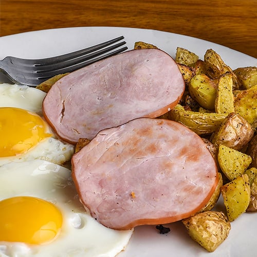 canadian bacon with fried eggs and home fries