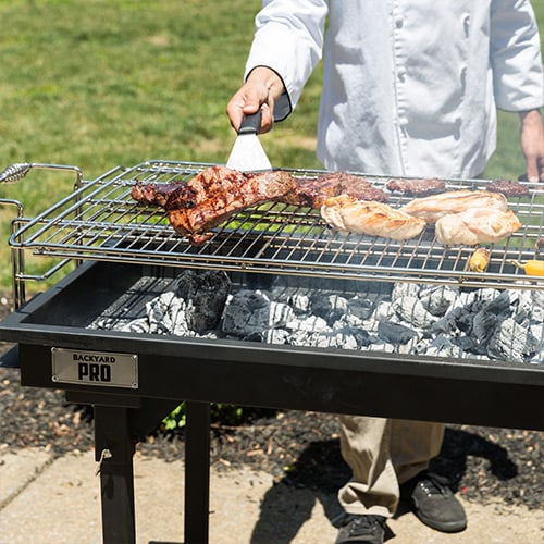 Charcoal grill with grilled chicken being cooked