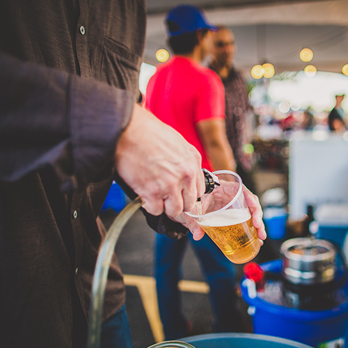 A bartender pouring beer from a keg