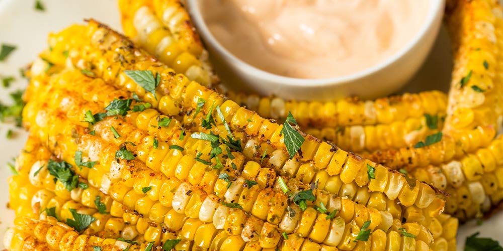 Close up of seasoned corn ribs on plate