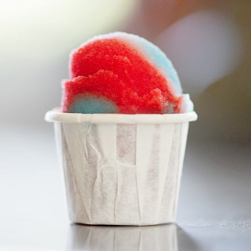 small tasting cup of mixed red and blue italian ice