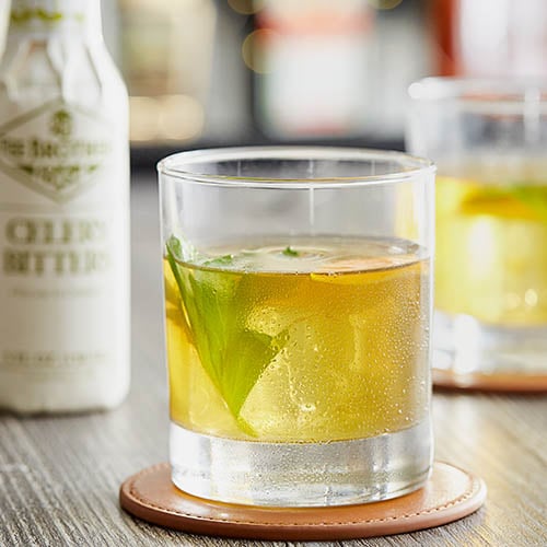 Bottle of celery bitters and a celery cocktail