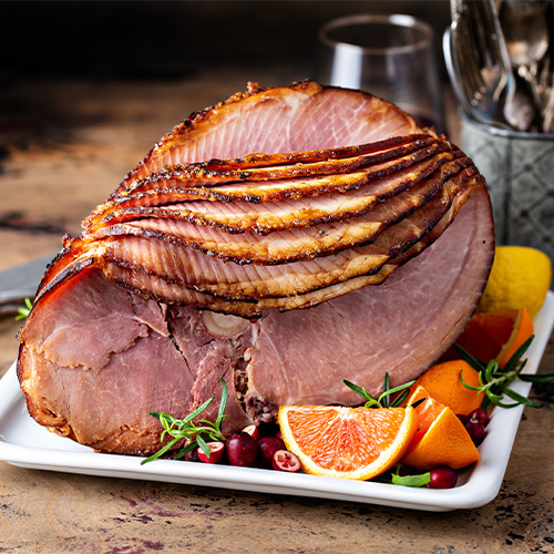 Bone in Ham on plate with fresh orange slices