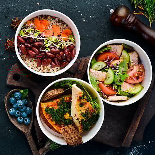 lunch dishes on a dark tabletop, overhead view