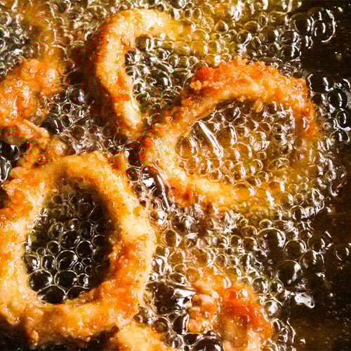 Battered calamari rings frying in oil