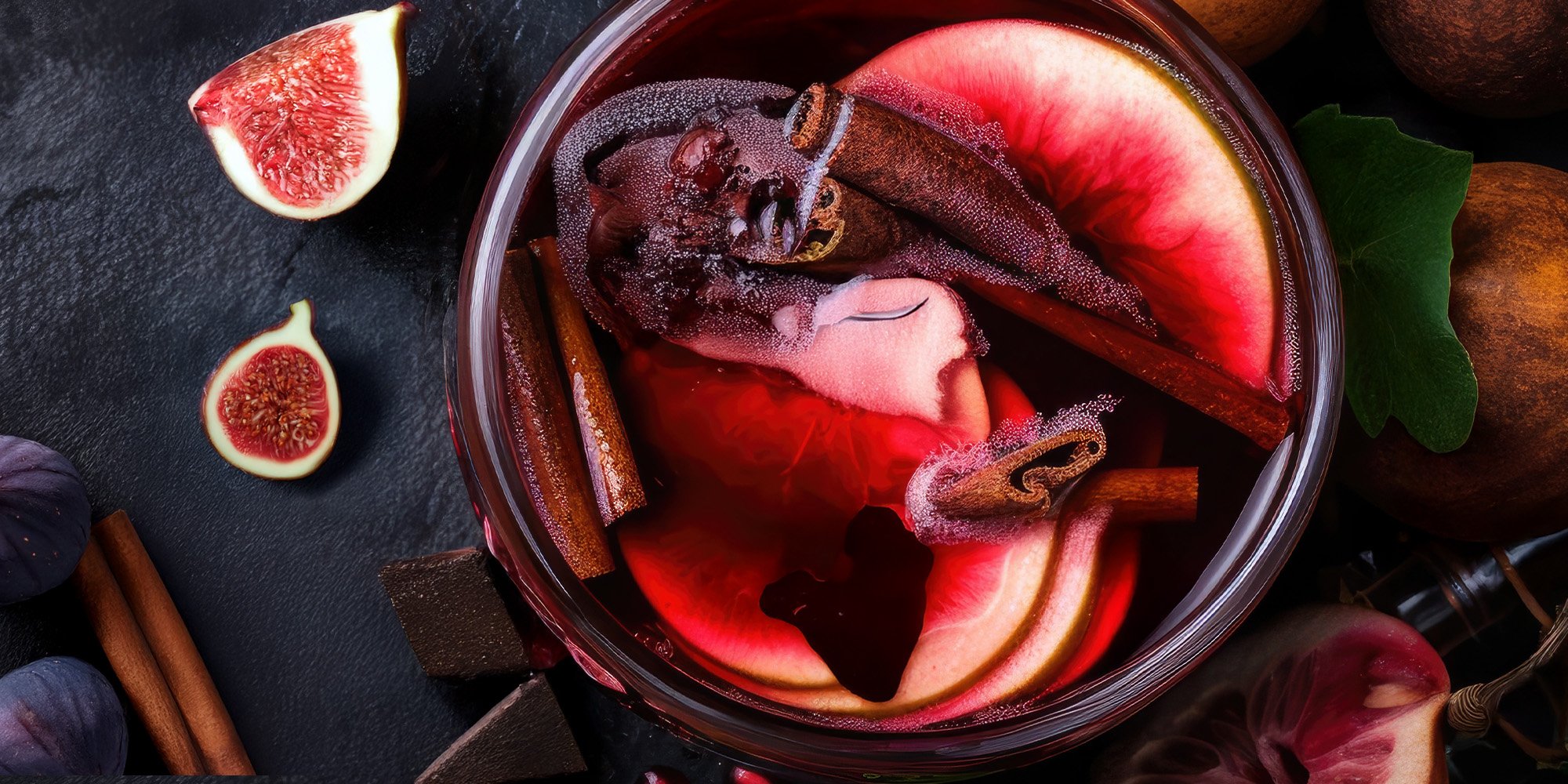 Overhead image of a fall sangria on a black countertop