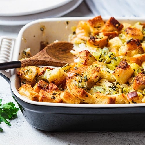 cooked stuffing in a dish with a spoon