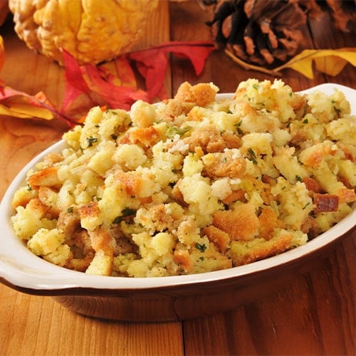 cornbread stuffing on a table with pumpkin and pinecones