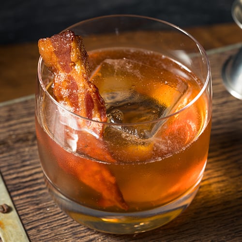 close up of cocktail with bacon in it