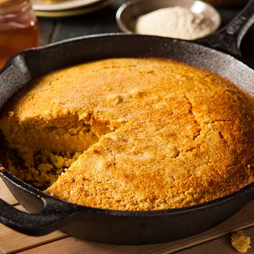close up of corn bread in a cast iron pan