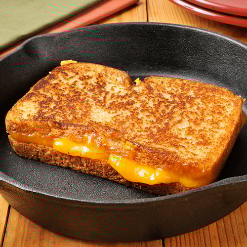 close up of grilled cheese in a cast iron pan