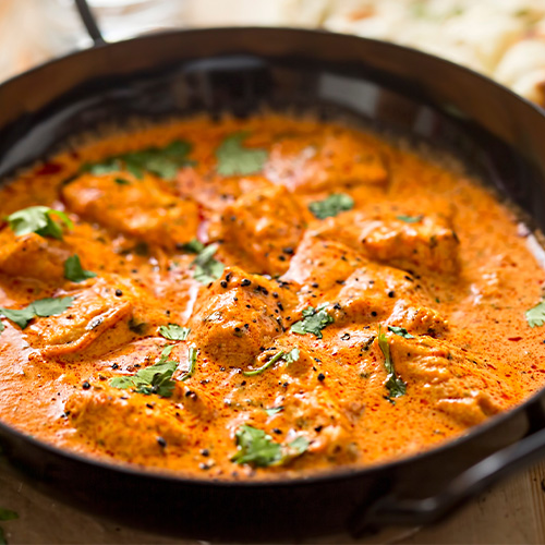 Close up of butter chicken in a cooking pan