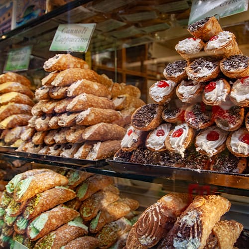 Closeup of olive oil pouring onto a salad