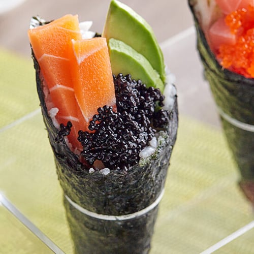 close up seaweed sushi roll with caviar, salmon, and avocado