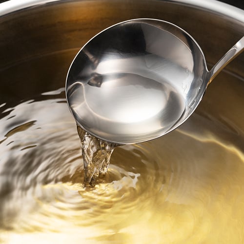 A ladle in a pot full of Dashi