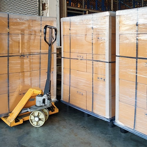 Stack cardboard boxes wrapping plastic on pallets and hand pallet truck, Cargo export shipment, warehouse industrial service logistics, Shipment goods transport