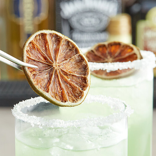 placing a garnish into a cocktail glass