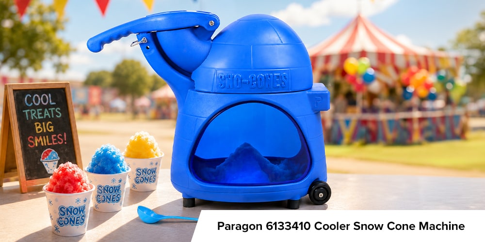 Paragon Cooler blue snow cone machine at a sunny carnival with finished snow cones and a chalkboard sign.