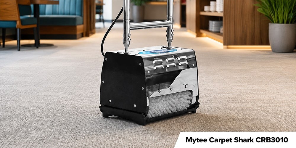 Mytee Carpet Shark CRB3010 - Black and stainless steel Mytee Carpet Shark carpet sweeper standing on light gray commercial carpeting.