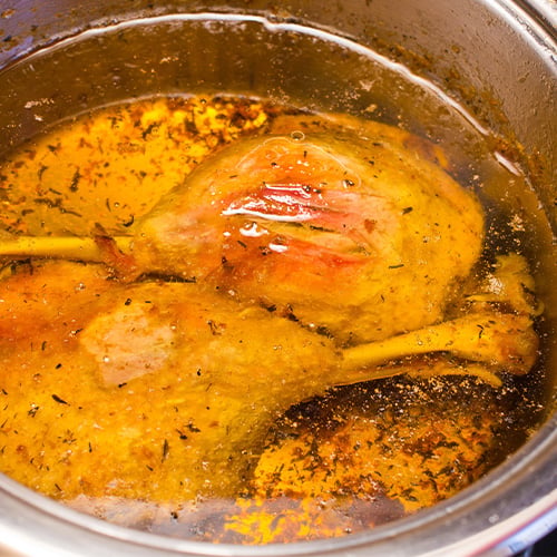 Traditional slow cooked duck confit in the pot