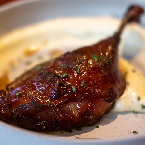 Tender duck confit with crispy skin, served with mashed potato