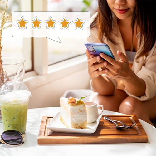 woman using her phone to give a 5 star review rating