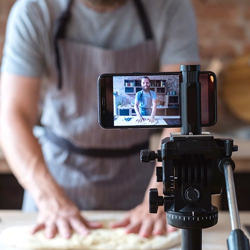 a man recording a TikTok to teach professional baking tips