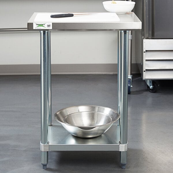 A Regency stainless steel work table with a metal bowl on it.