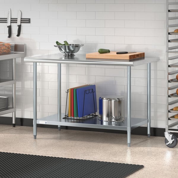 A Steelton stainless steel work table with an undershelf in a professional kitchen.