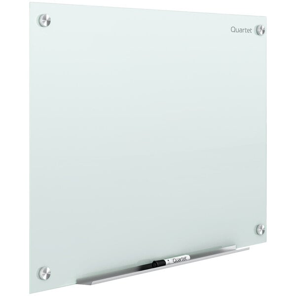 A white frameless magnetic glass markerboard with a black marker on it.