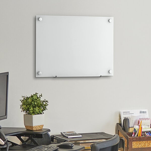 A Dynamic by 360 Office Furniture frameless frosted glass dry erase board on a wall.
