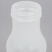 A Tablecraft clear plastic syrup dispenser bottle with an almond cap.