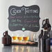 A vinyl chalkboard label on a table with "Cider Tasting" written on it.
